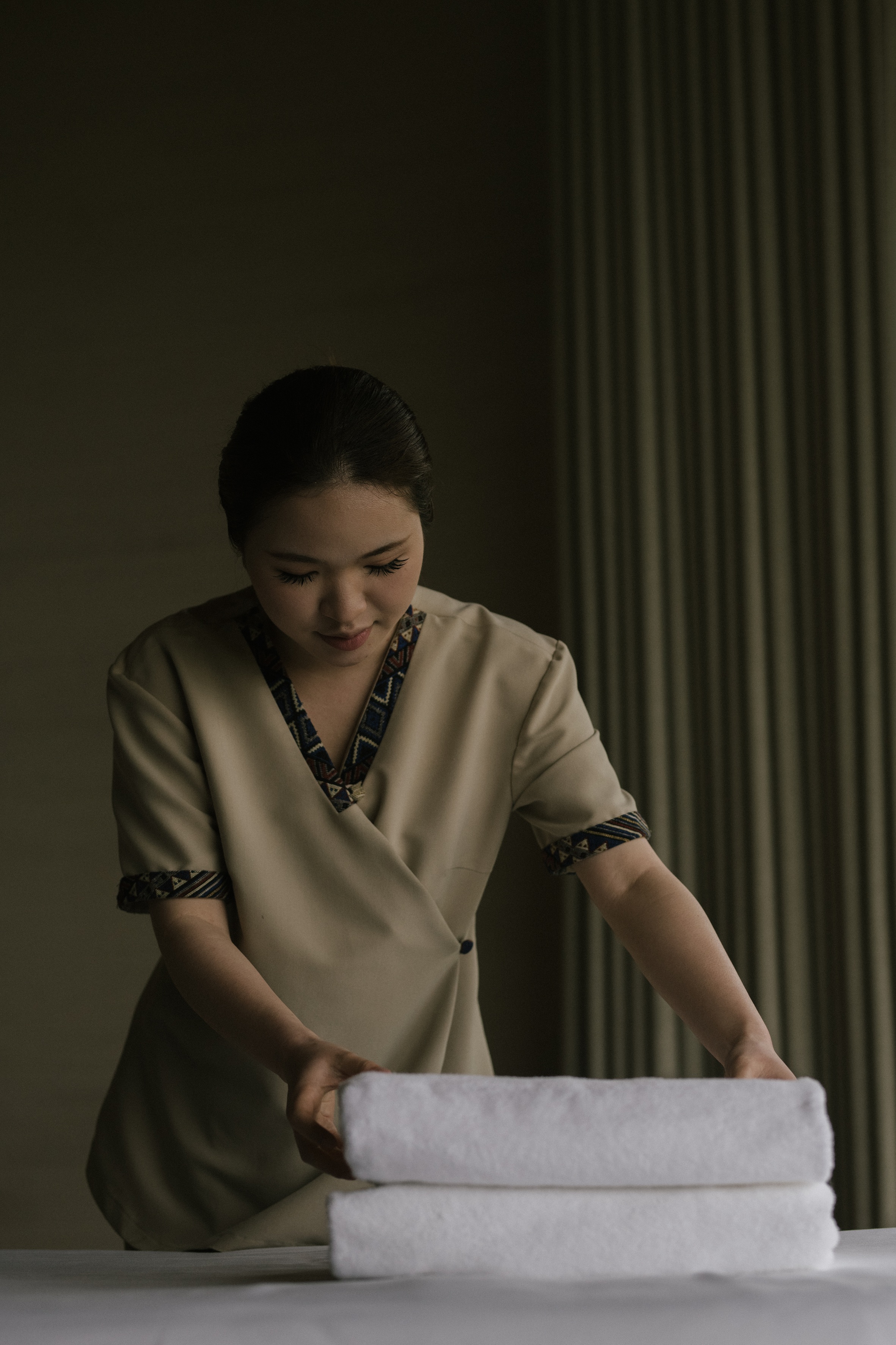 Garrya associate preparing a guest room without single-use plastics