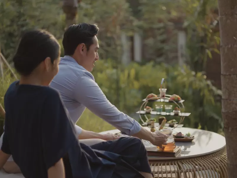 Man and woman are having afternoon tea time amidst the greenery