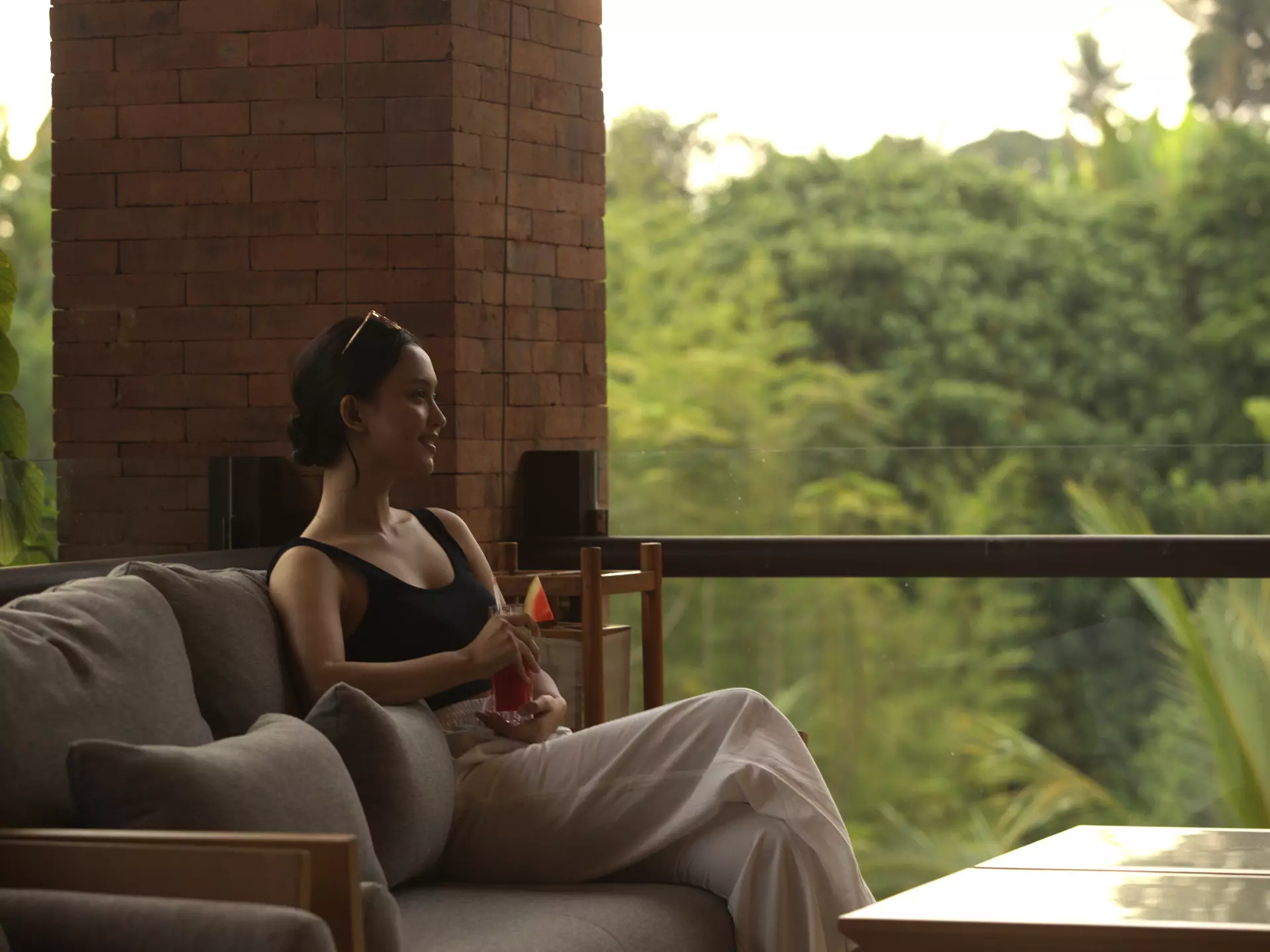 A women is relaxing oin a chari amidst the serene nature