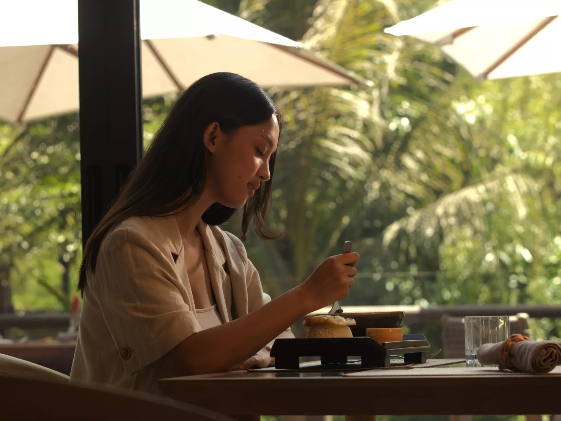 A woman is eating at the resto