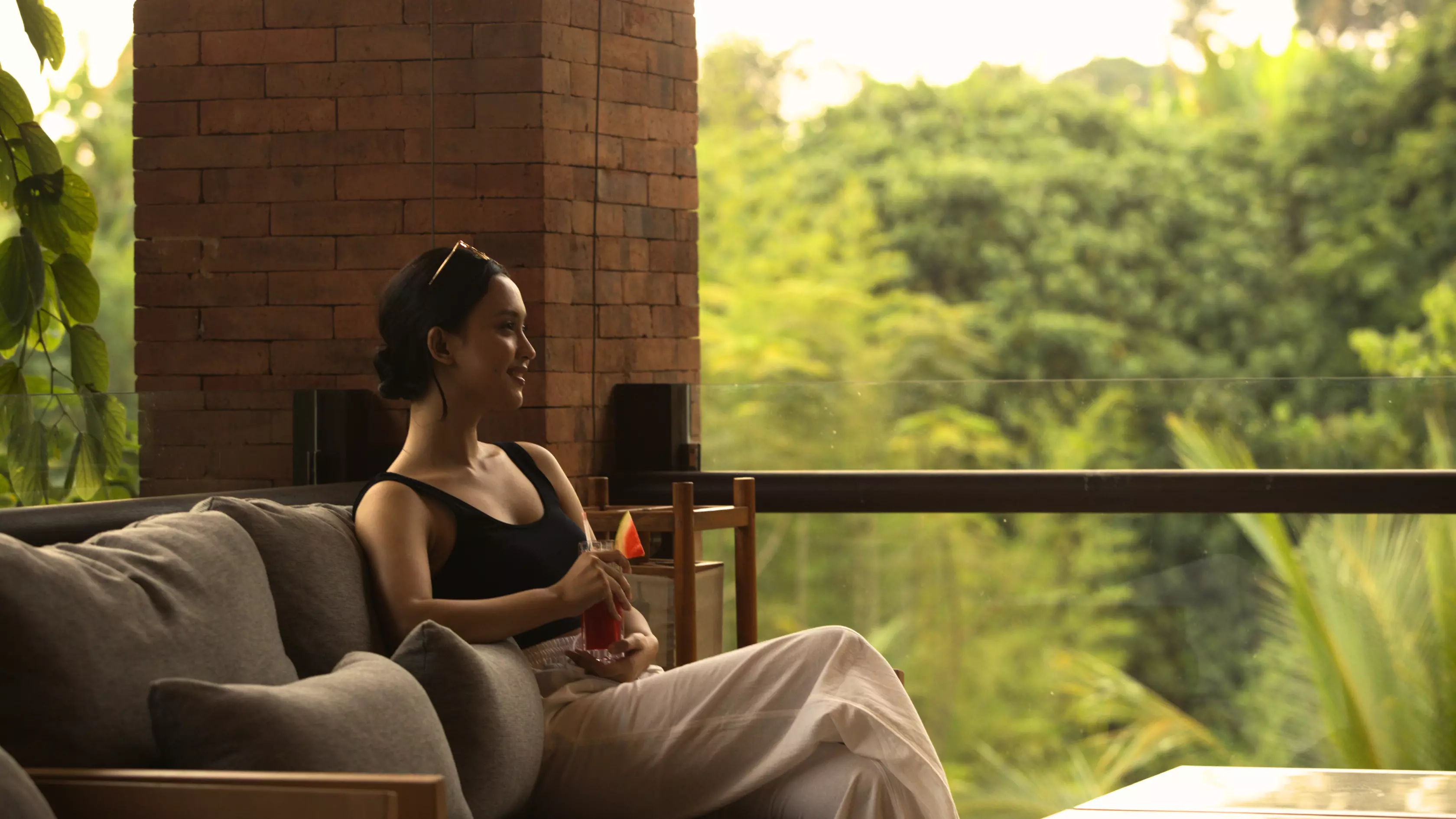 A woman is enjoying a healthy drink at Kopi Zop