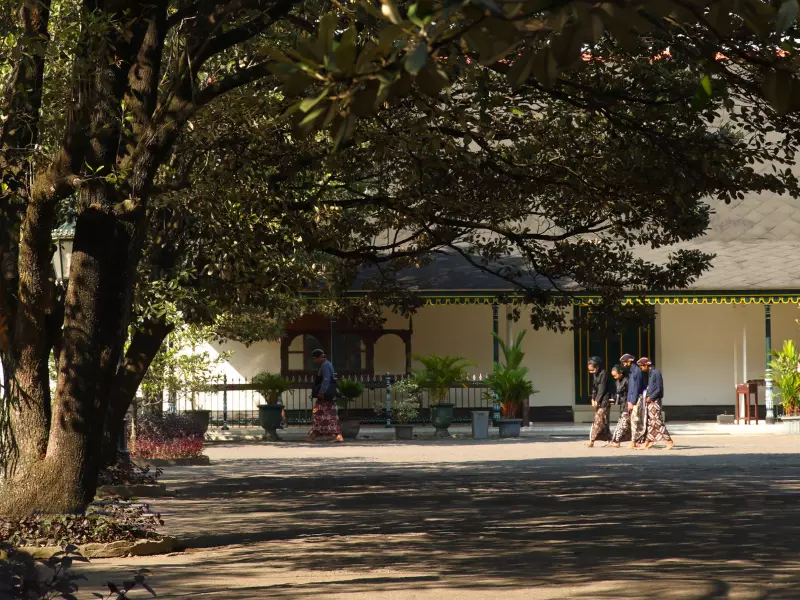 Royal servants are walking inside of the Sultan Palace