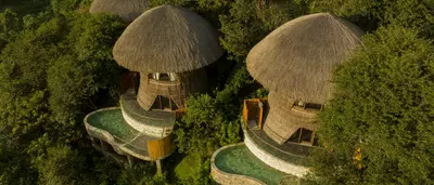 Mù Cang Chải Pool Suite building with bamboo-inspired architecture, surrounded by mountains, rice terraces, and a private pool.