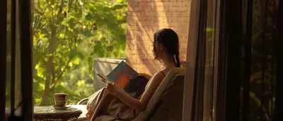 A woman is reading in hotel room