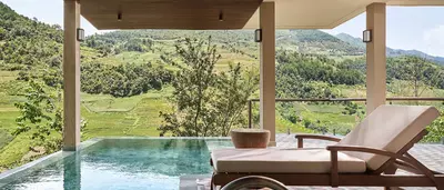 Private pool terrace overlooking Mu Cang Chai’s terraced rice fields and lush mountain landscape.