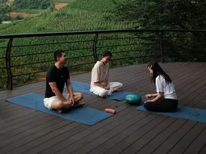 Breathing yoga session at Garrya Mu Cang Chai with mountain view.