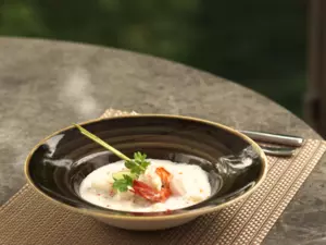 A plate of food on the table with greeneries background