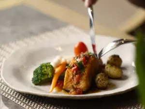 A plate of food on the table with greeneries background