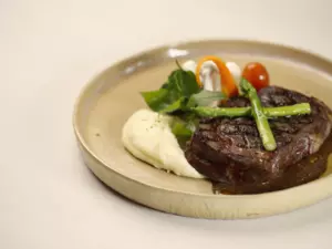 A plate of food on the table with greeneries background