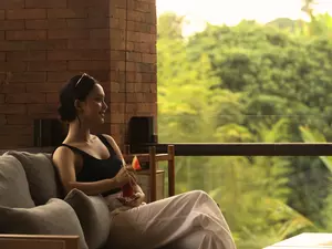 A woman is enjoying a healthy drink at Kopi Zop