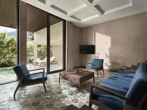 Living area of the Hmong Garden View Pool Suite overlooking mountain and rice terrace scenery.