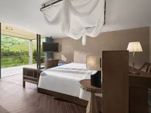 Grand Deluxe Room King bedroom with mountain and rice terrace view from the terrace.