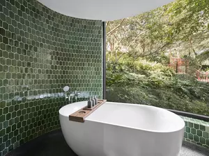 Wellbeing Suite Twin bathroom with a relaxing bathtub.