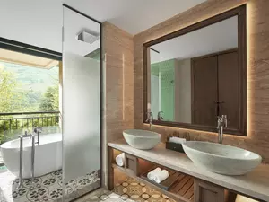 Bathroom of the Hmong Garden View Pool Suite featuring a relaxing bathtub.