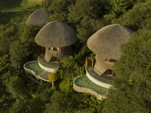 Mù Cang Chải Pool Suite building with bamboo-inspired architecture, surrounded by mountains, rice terraces, and a private pool.