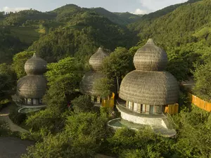 Mù Cang Chải Pool Suite building with bamboo-inspired architecture, surrounded by mountains, rice terraces, and a private pool.